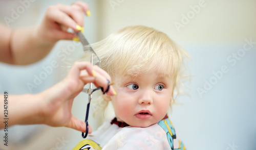 Fotografie Toddler child getting his first haircut