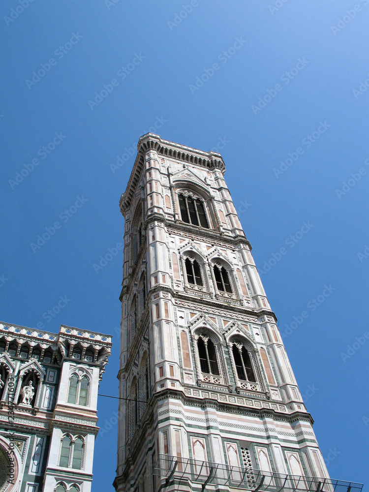 Campanile Giotto in Florence, Italy, fourteenth century masterpiece of architecture, bottom view against blue sky
