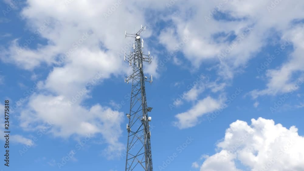 Communication tower with cellphone receivers and transmitters. White clouds and blue sky. Ontario, Canada. Communication tower with cellphone receivers and transmitters. White clouds and blue sky. Ontario, Canada.