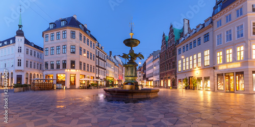 Stork Fountain on the Amagertorv square, Stroget street during morning blue hour, Copenhagen, capital of Denmark photo