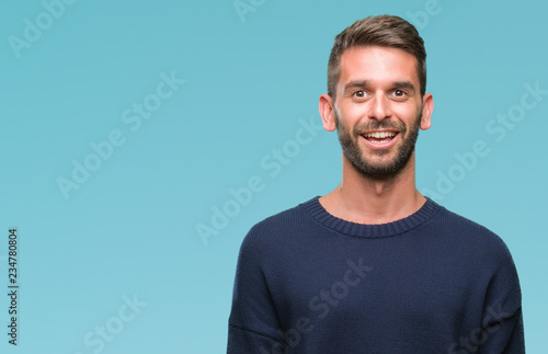 Young handsome man wearing winter sweater over isolated background with a happy and cool smile on face. Lucky person. © Krakenimages.com