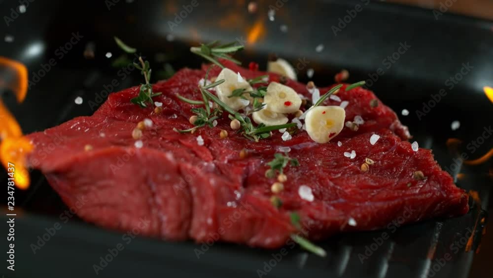 Super slow motion of falling beef steak into flames. Filmed on high speed cinema camera, 1000 fps. Super slow motion of falling beef steak into flames. Filmed on high speed cinema camera, 1000 fps.