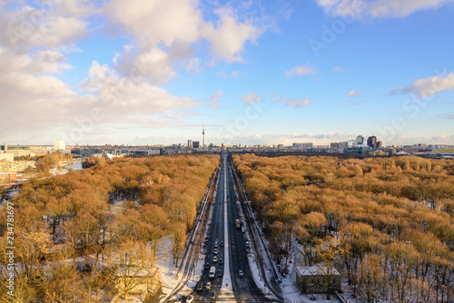 Aerial panoramic view of cityscape of Berlin skyline and scenery of trees without leaves in winter season at Tiergarten park from above at Victory Column with background of dusk sunset sky in Berlin.