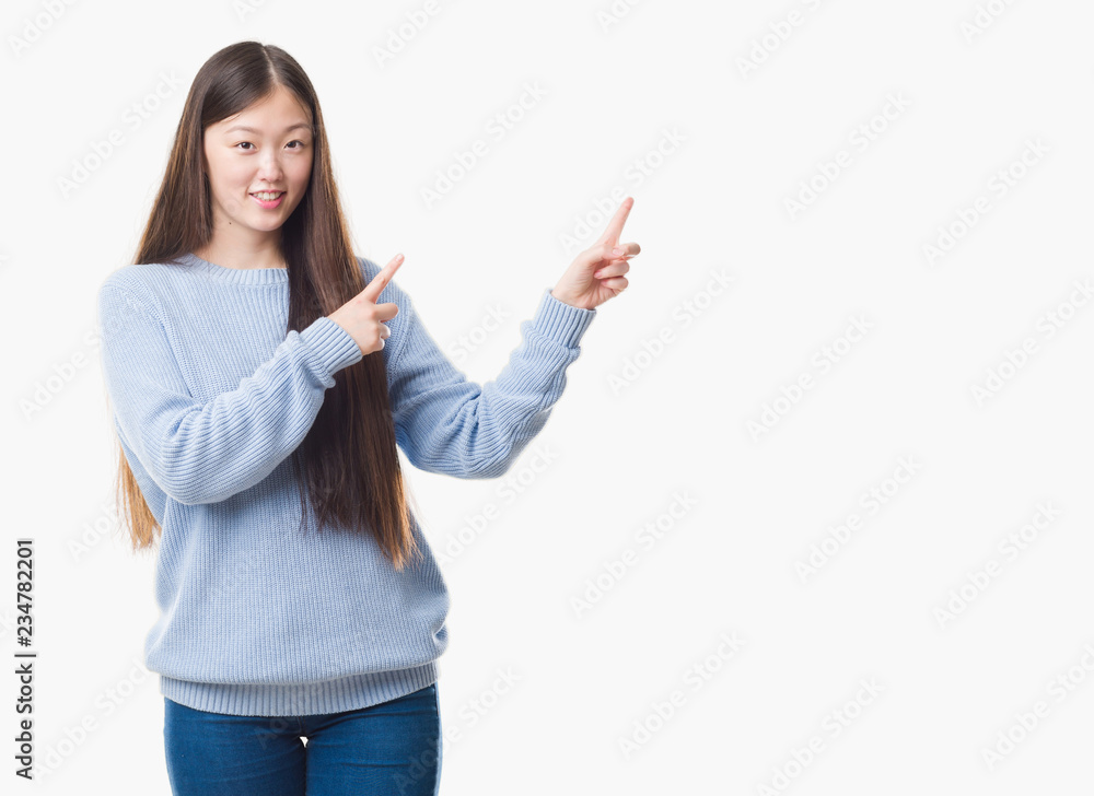 Young Chinese woman over isolated background smiling and looking at the camera pointing with two hands and fingers to the side. Young Chinese woman over isolated background smiling and looking at the camera pointing with two hands and fingers to the side.