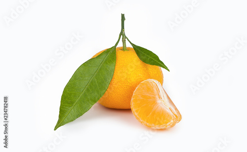 yellow sweet isolated peeled and whole mandarin clementine tangerine on white copy space with leaf. Tangerines background concept
