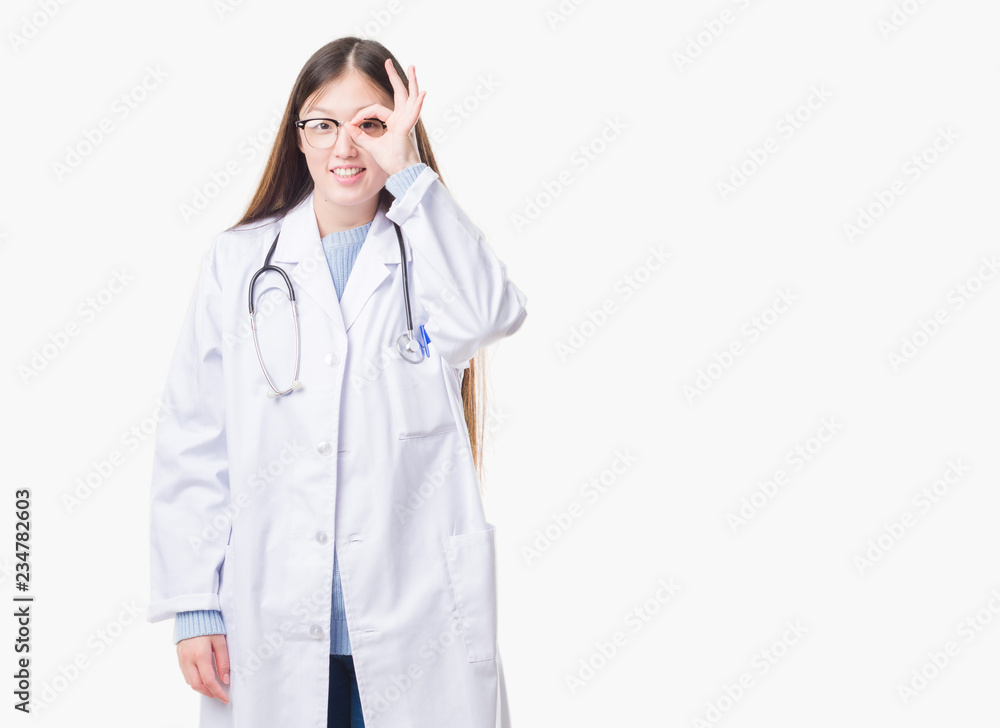 Young Chinese doctor woman over isolated background doing ok gesture with hand smiling, eye looking through fingers with happy face. Young Chinese doctor woman over isolated background doing ok gesture with hand smiling, eye looking through fingers with happy face.