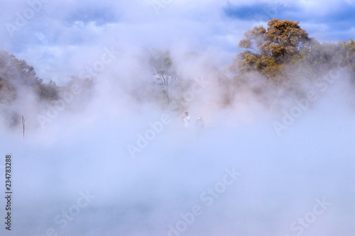 Tourists taking photo in steaming hot area of Kuirau Park, Rotorua
