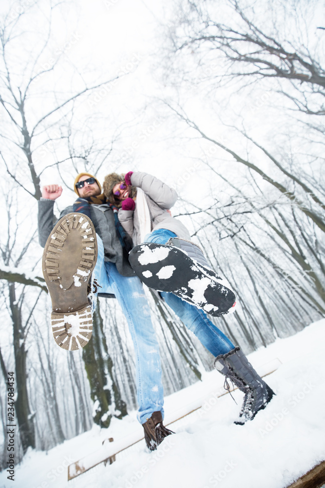 Young couple having fun in snow