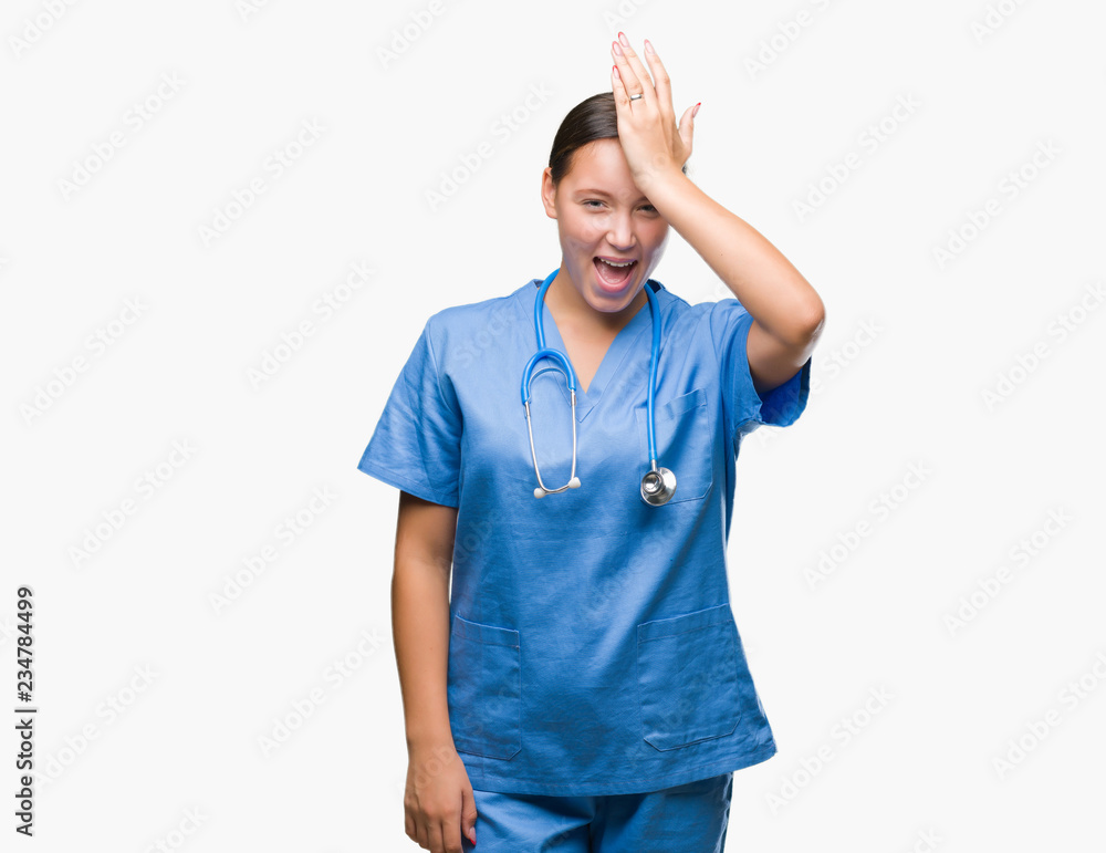 Young caucasian doctor woman wearing medical uniform over isolated background surprised with hand on head for mistake, remember error. Forgot, bad memory concept. Young caucasian doctor woman wearing medical uniform over isolated background surprised with hand on head for mistake, remember error. Forgot, bad memory concept.