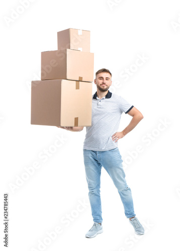 Full length portrait of young man holding carton boxes on white background. Posture concept