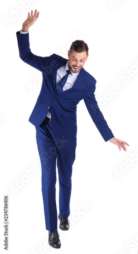 Full length portrait of businessman balancing on white background