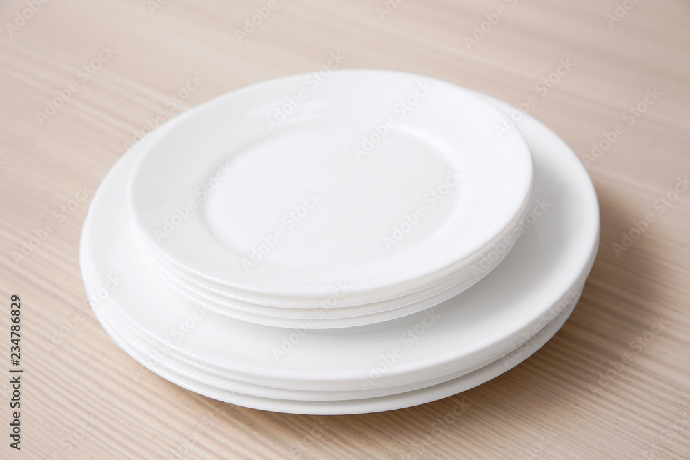 Stack of clean dishes on wooden table Stack of clean dishes on wooden table