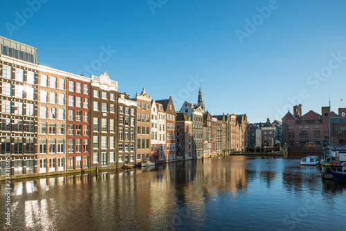 Amsterdam city view of Netherlands traditional houses with Amstel river in Amsterdam, Netherlands