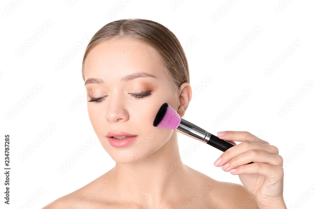 Portrait of beautiful young woman with makeup brush on white background Portrait of beautiful young woman with makeup brush on white background