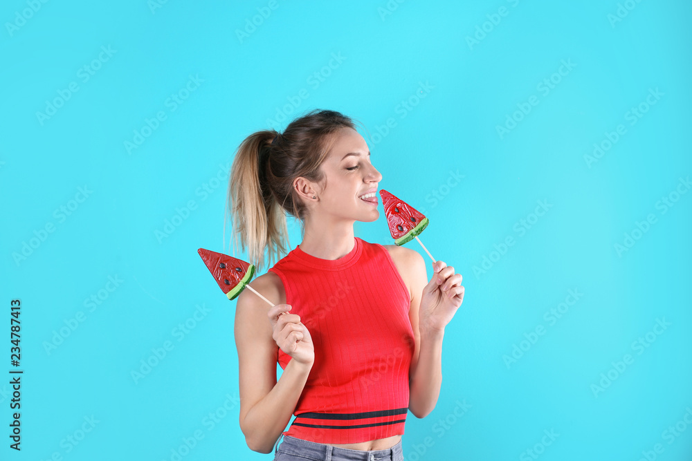 Young pretty woman with candies on colorful background Young pretty woman with candies on colorful background