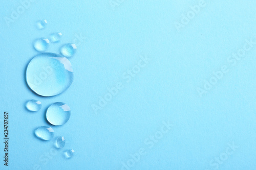 Water drops on color background  top view. Space for text
