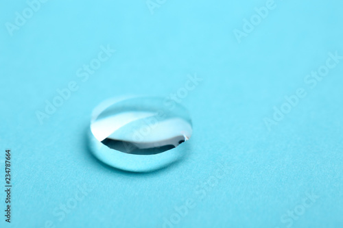 Pure water drop on color background, closeup. Space for text
