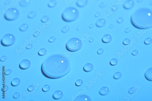 Pure water drops on color background, closeup
