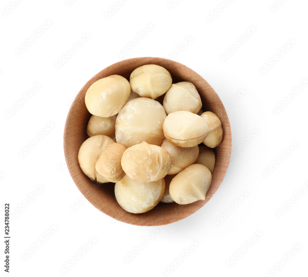 Bowl with shelled organic Macadamia nuts on white background, top view Bowl with shelled organic Macadamia nuts on white background, top view