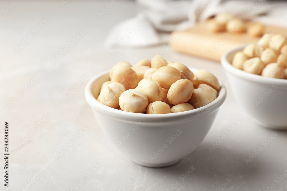 Bowl with shelled organic Macadamia nuts on light table Bowl with shelled organic Macadamia nuts on light table