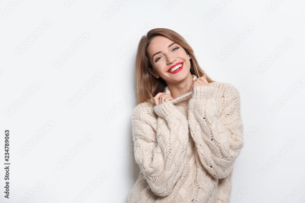 Beautiful young woman in warm sweater on white background. Space for text Beautiful young woman in warm sweater on white background. Space for text