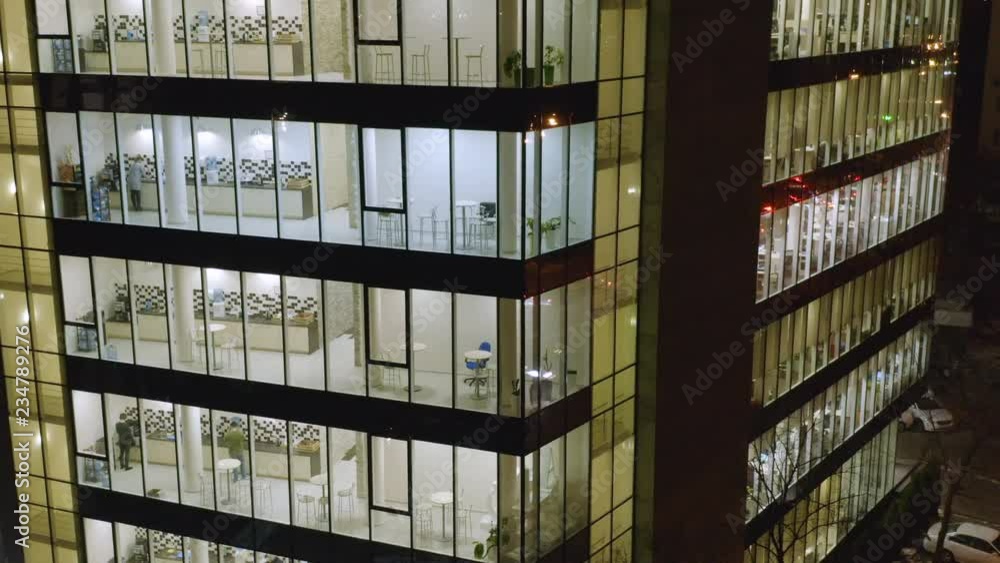 Aerial view of the glassed office with glowing windows at night Aerial view of the glassed office with glowing windows at night