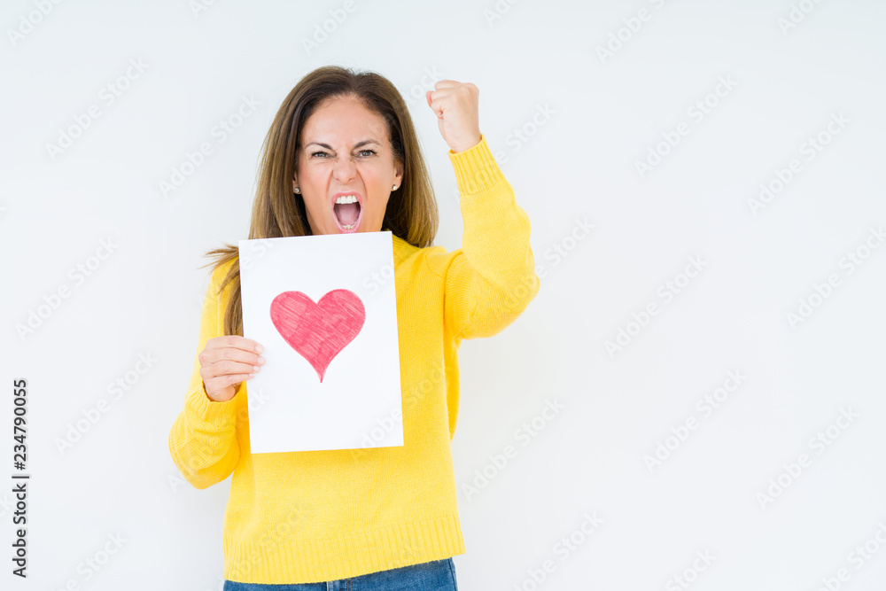 Middle age woman holding card gift with red heart over isolated background annoyed and frustrated shouting with anger, crazy and yelling with raised hand, anger concept Middle age woman holding card gift with red heart over isolated background annoyed and frustrated shouting with anger, crazy and yelling with raised hand, anger concept