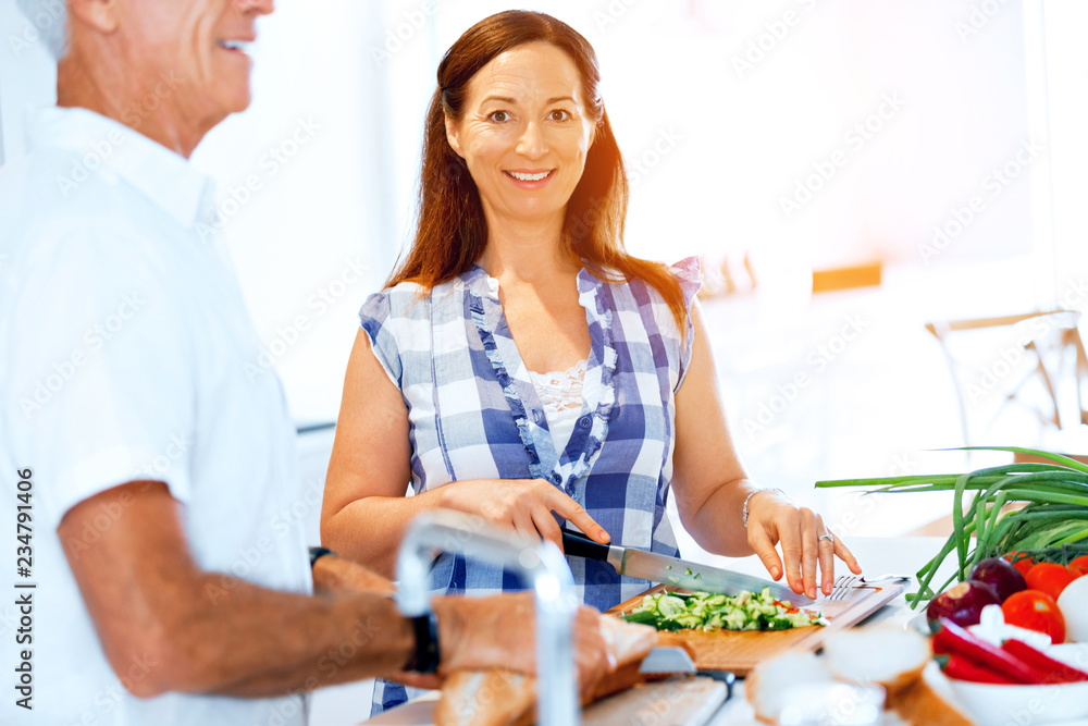 Mature couple cooking at home