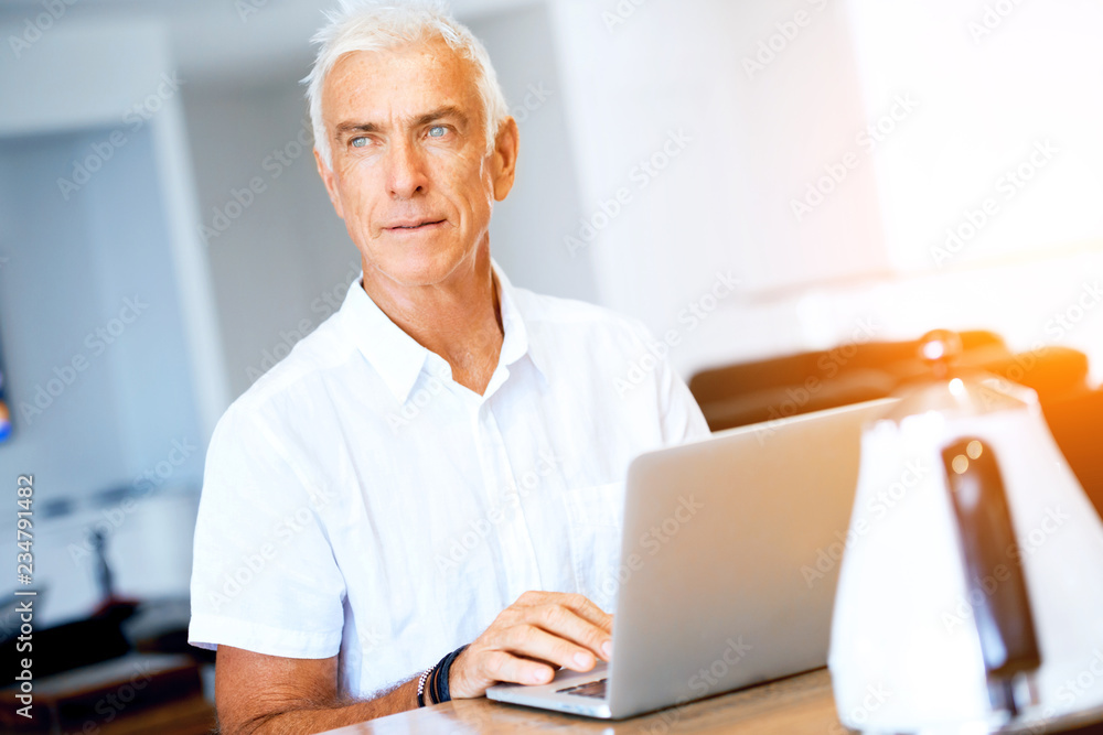 Man working on laptop at home Man working on laptop at home