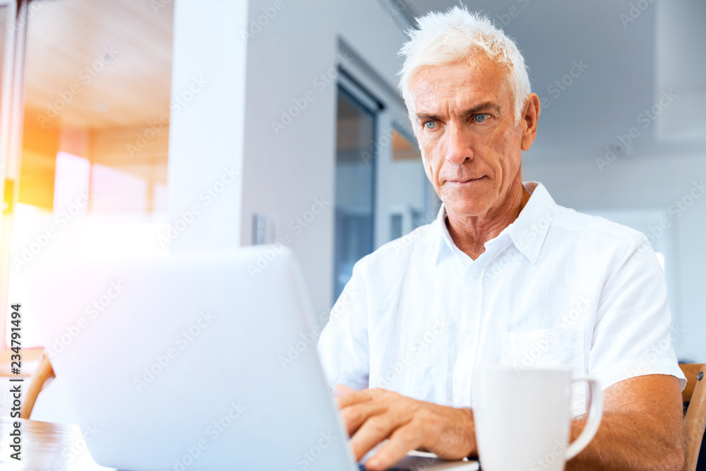 Man working on laptop at home Man working on laptop at home