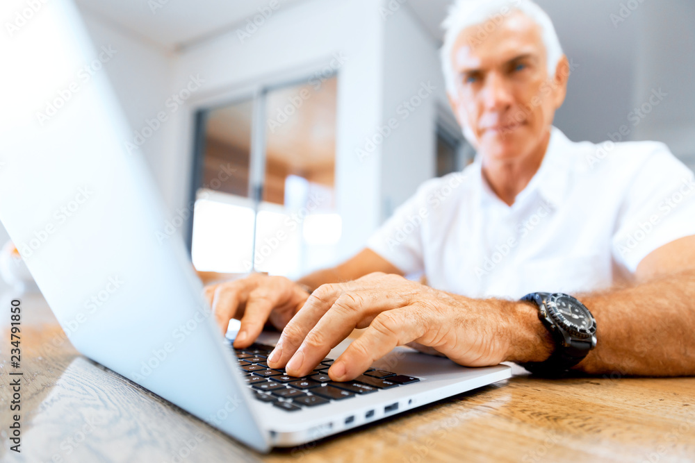 Man working on laptop at home Man working on laptop at home