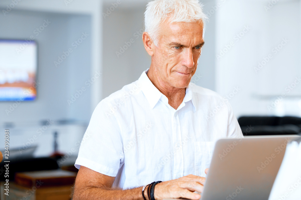 Man working on laptop at home Man working on laptop at home