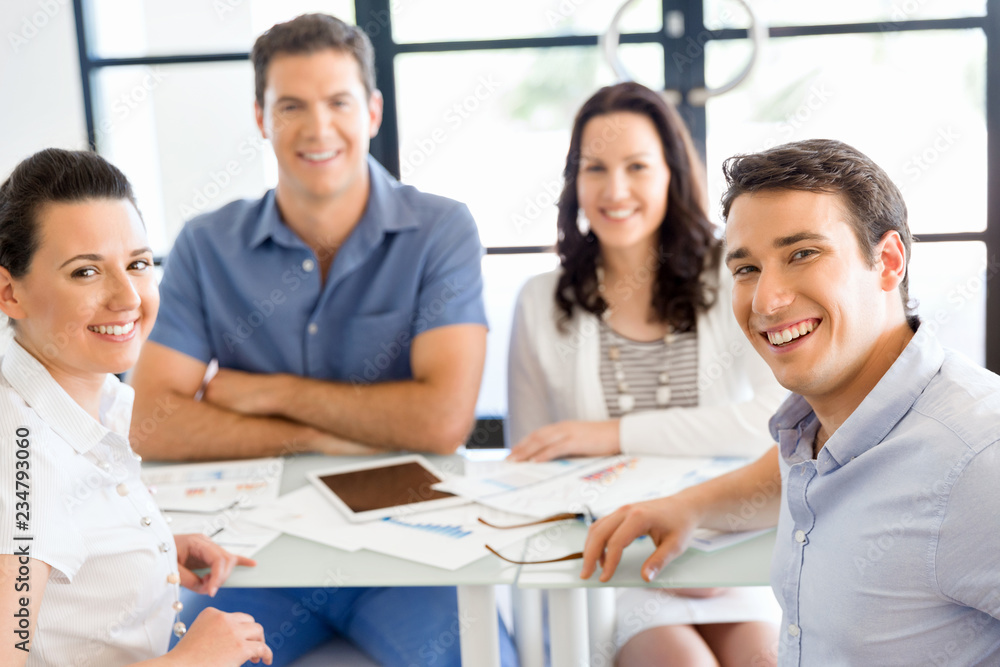 Image of business partners discussing documents and ideas Image of business partners discussing documents and ideas
