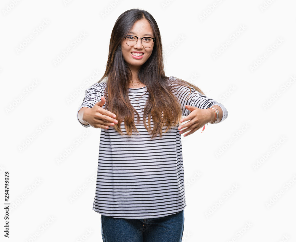 Young asian woman wearing glasses over isolated background looking at the camera smiling with open arms for hug. Cheerful expression embracing happiness. Young asian woman wearing glasses over isolated background looking at the camera smiling with open arms for hug. Cheerful expression embracing happiness.