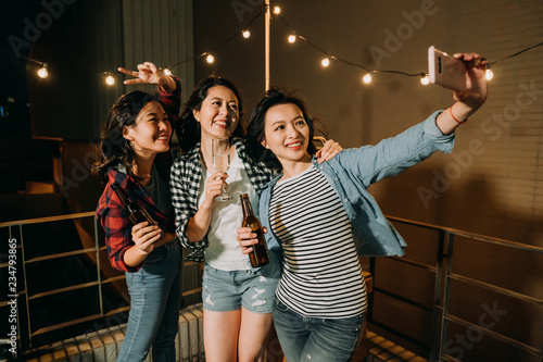 Canvas Print asian girls taking self portrait on rooftop party