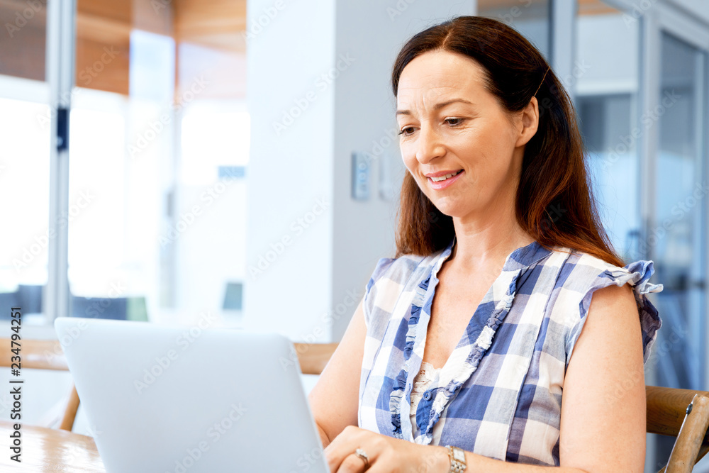 Mature beautiful woman working on her laptop Mature beautiful woman working on her laptop