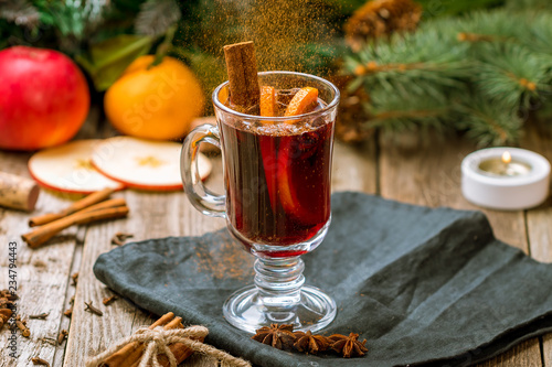 Mulled wine on old wooden background