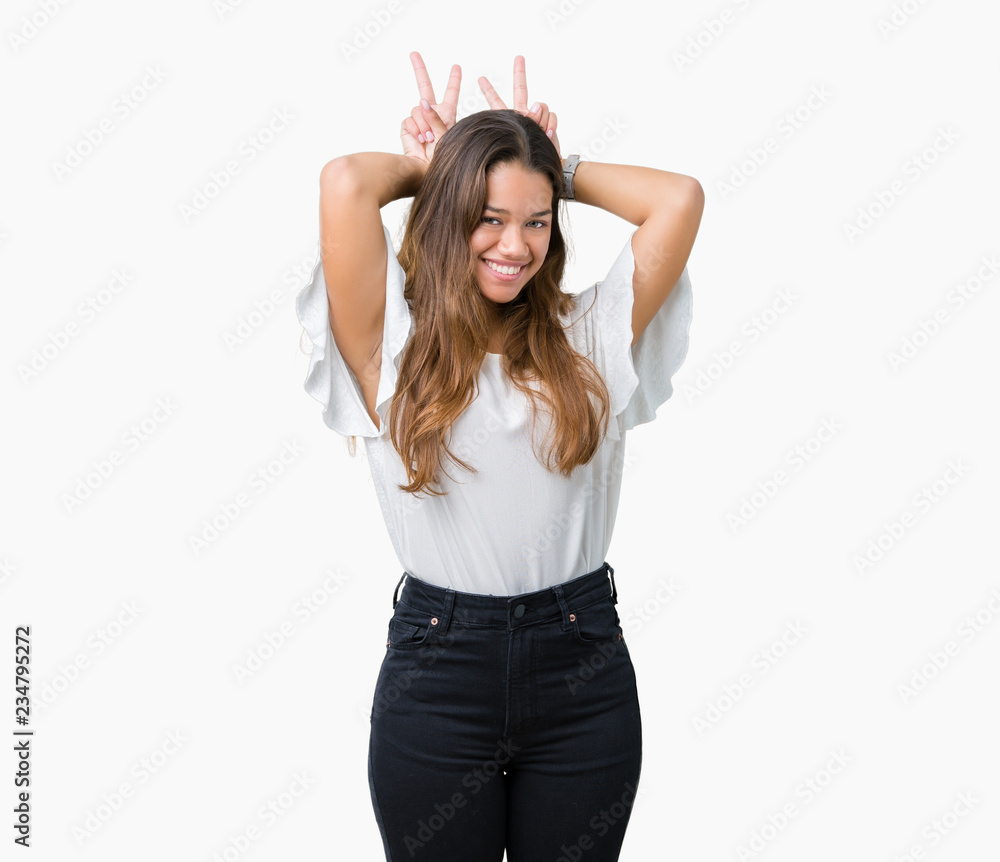 Young beautiful brunette business woman over isolated background Posing funny and crazy with fingers on head as bunny ears, smiling cheerful Young beautiful brunette business woman over isolated background Posing funny and crazy with fingers on head as bunny ears, smiling cheerful