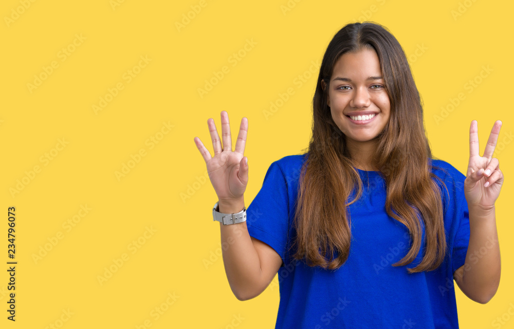 Young beautiful brunette woman wearing blue t-shirt over isolated background showing and pointing up with fingers number seven while smiling confident and happy.