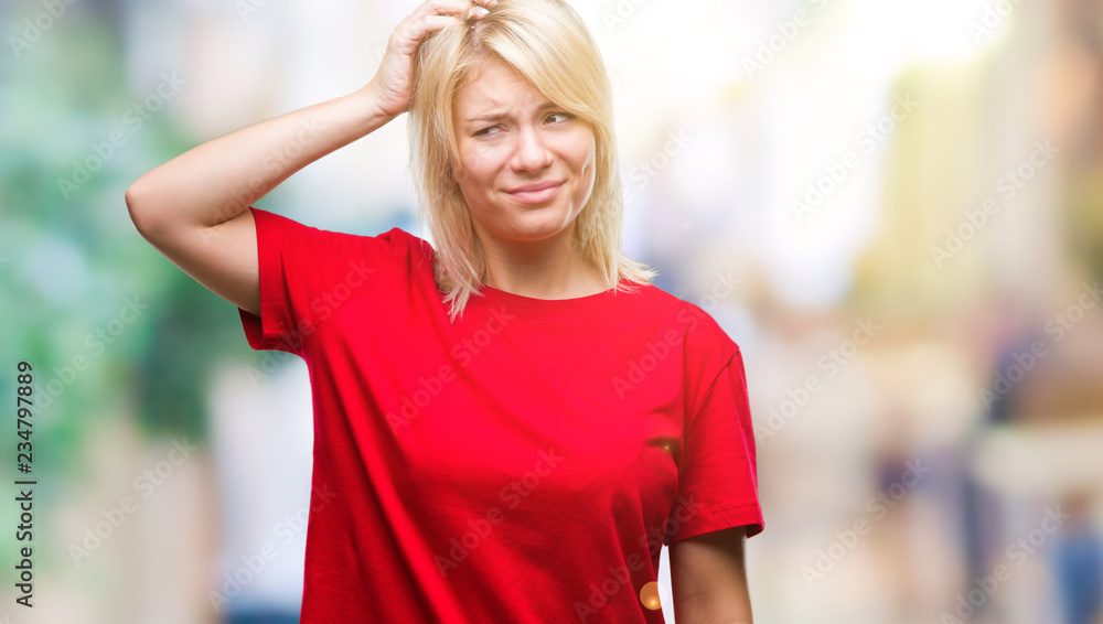 Young beautiful blonde woman wearing red t-shirt over isolated background confuse and wonder about question. Uncertain with doubt, thinking with hand on head. Pensive concept.