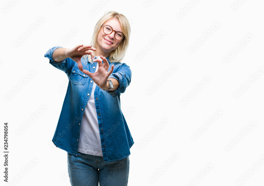 Young beautiful blonde woman wearing glasses over isolated background smiling in love showing heart symbol and shape with hands. Romantic concept. Young beautiful blonde woman wearing glasses over isolated background smiling in love showing heart symbol and shape with hands. Romantic concept.