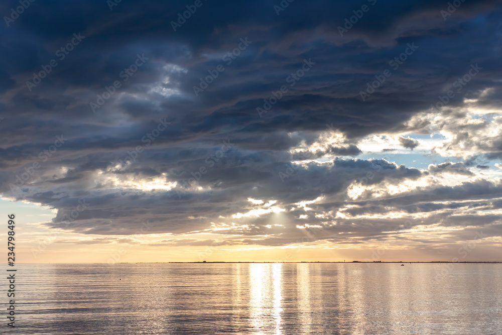 amazing sunset over the sea with dramatic clouds