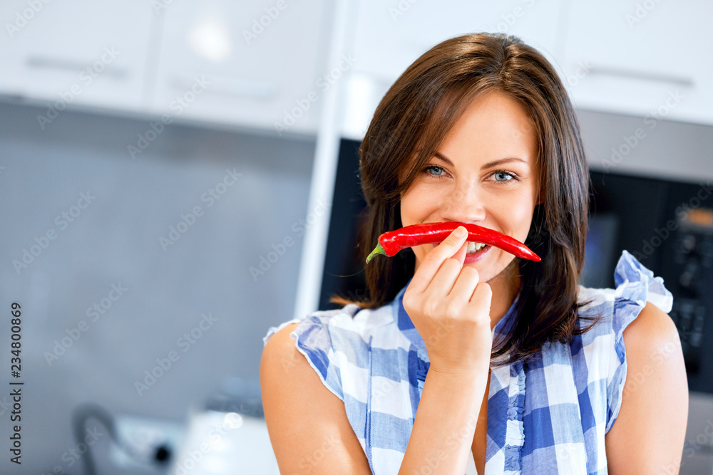 Young woman with red chilly pepper Young woman with red chilly pepper