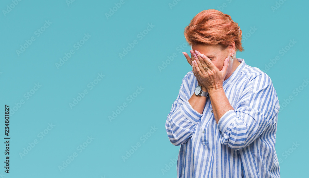 Atrractive senior caucasian redhead woman over isolated background with sad expression covering face with hands while crying. Depression concept. Atrractive senior caucasian redhead woman over isolated background with sad expression covering face with hands while crying. Depression concept.
