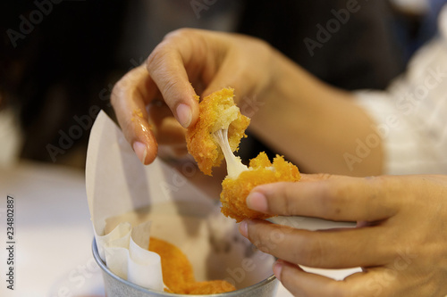Pulling fried Cheese Ball by hand