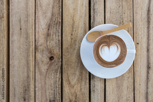 latte art coffe on wood table