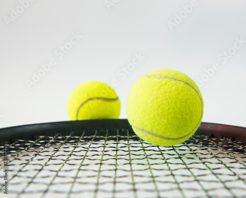 Close up of tennis ball and tennis racket isolated on white background © Asada
