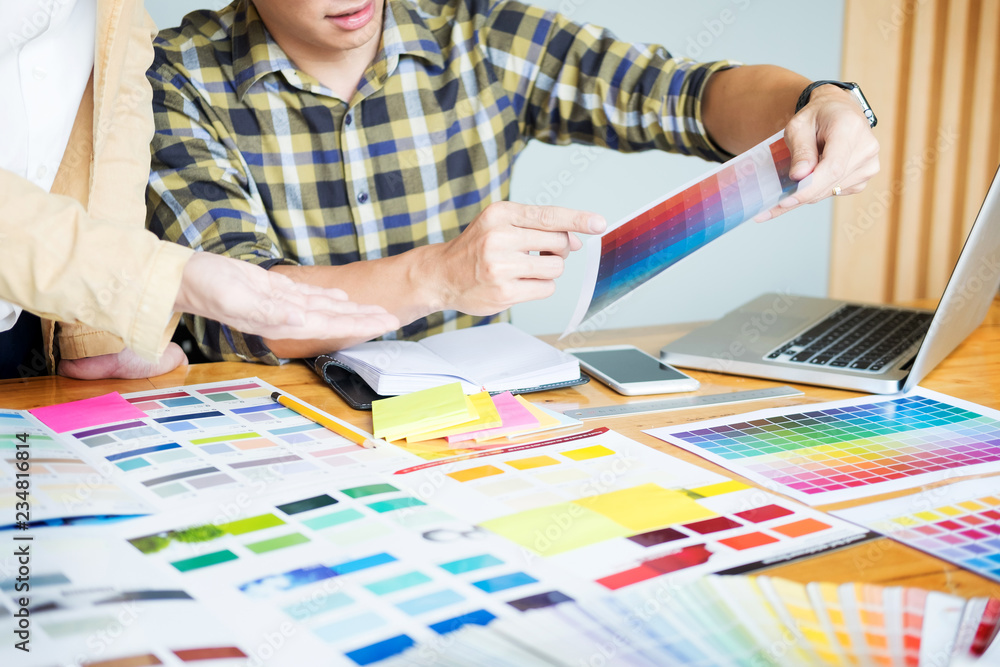 Professional Creative architect graphic desiner occupation choosing the Color pantone palette samples for project on office desktop computer. Professional Creative architect graphic desiner occupation choosing the Color pantone palette samples for project on office desktop computer.