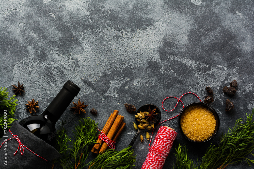 New Year food background. Ingredients for making Christmas mulled wine (bottle of red wine, orange, cane sugar and spices). Top view.