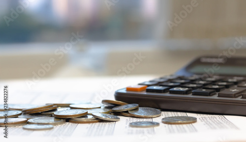 Financial report with coins and calculator on desk table.Financial concept. selected focus.